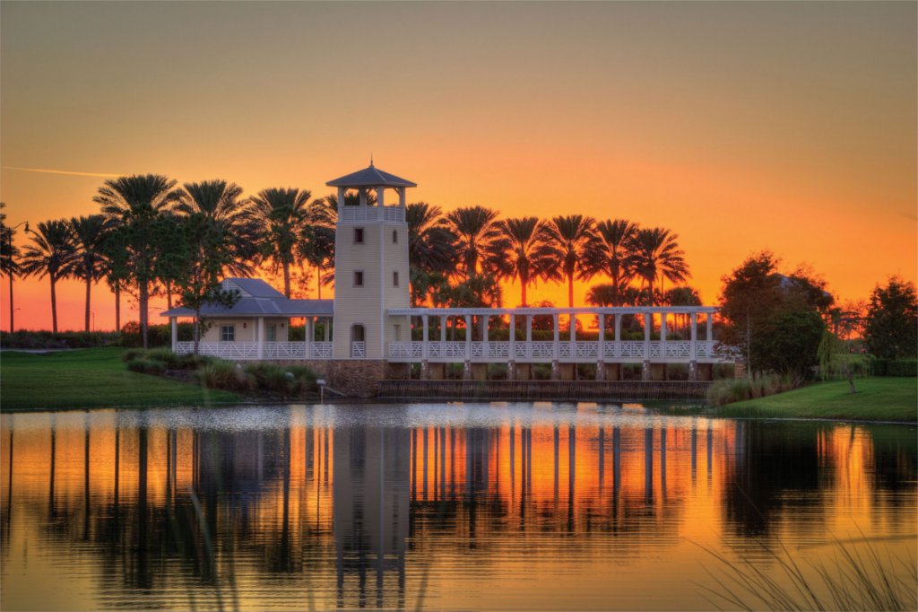 A lakeside tower and palms at sunset in Port St. Lucie