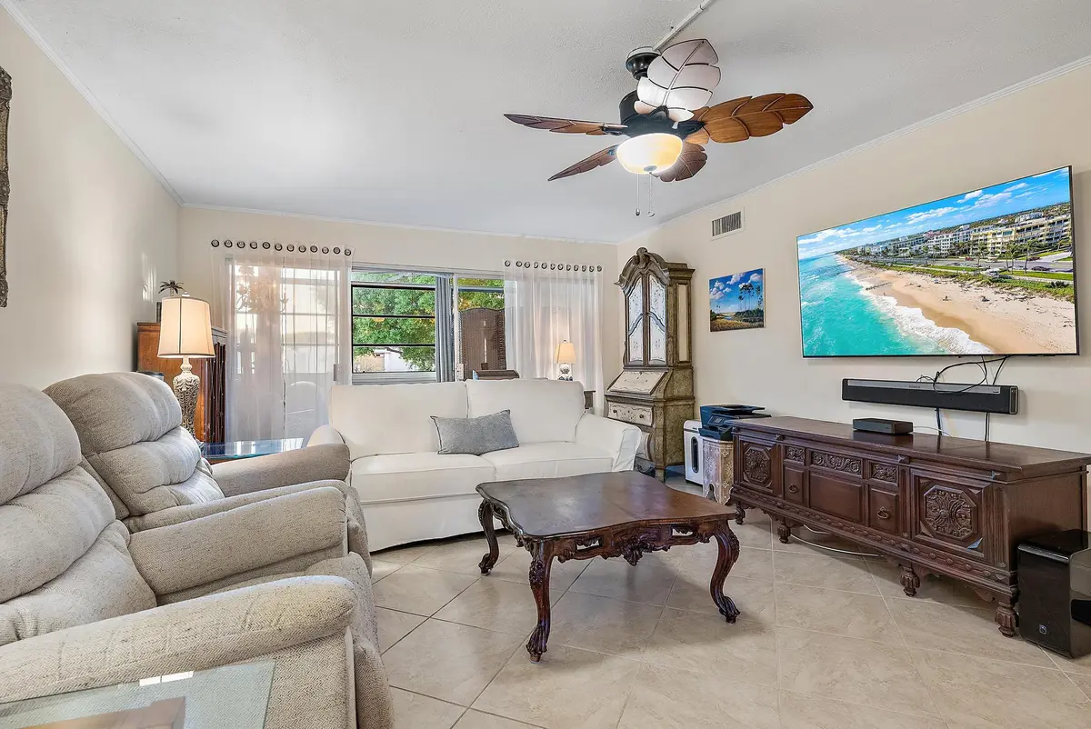 Living room and enclosed patio at 1561 NE 12th Terrace C-14, Jensen Beach