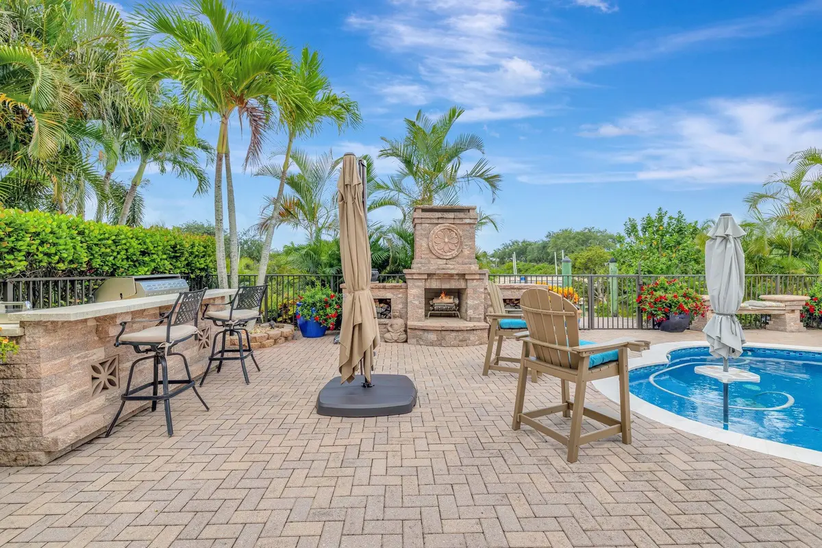 Patio/fireplace/pool /kichen/bar at 699 SW River Bend Circle, Stuart