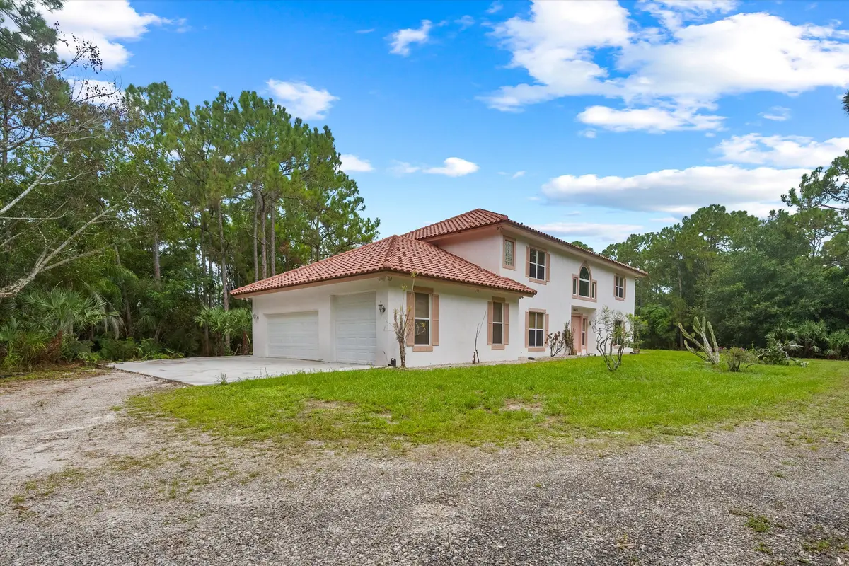 East Elevation & Garage at 18420 Windsong Way, Jupiter