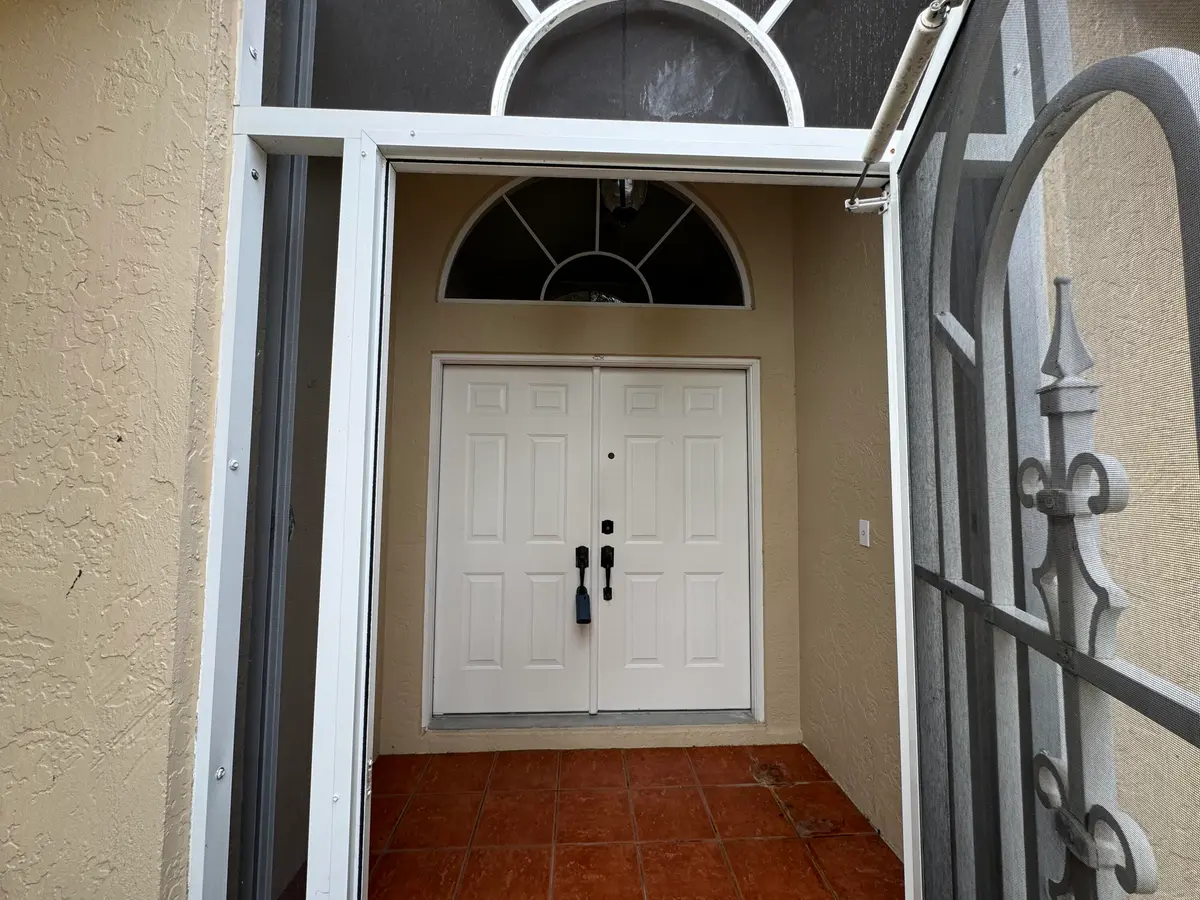 Screened Front Porch/Double front doors at 2705 Pointe Circle, Greenacres