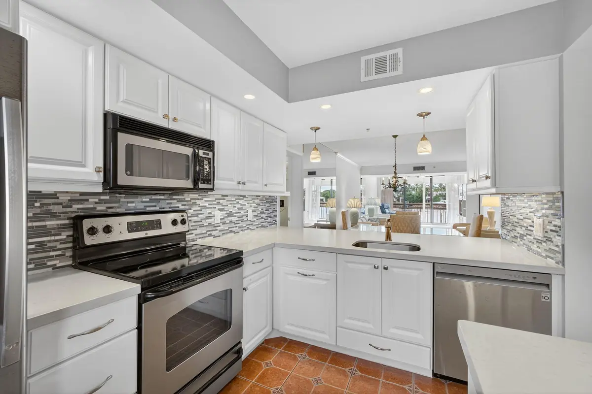 Kitchen opens to great room at 2201 Marina Isle Way 202, Jupiter