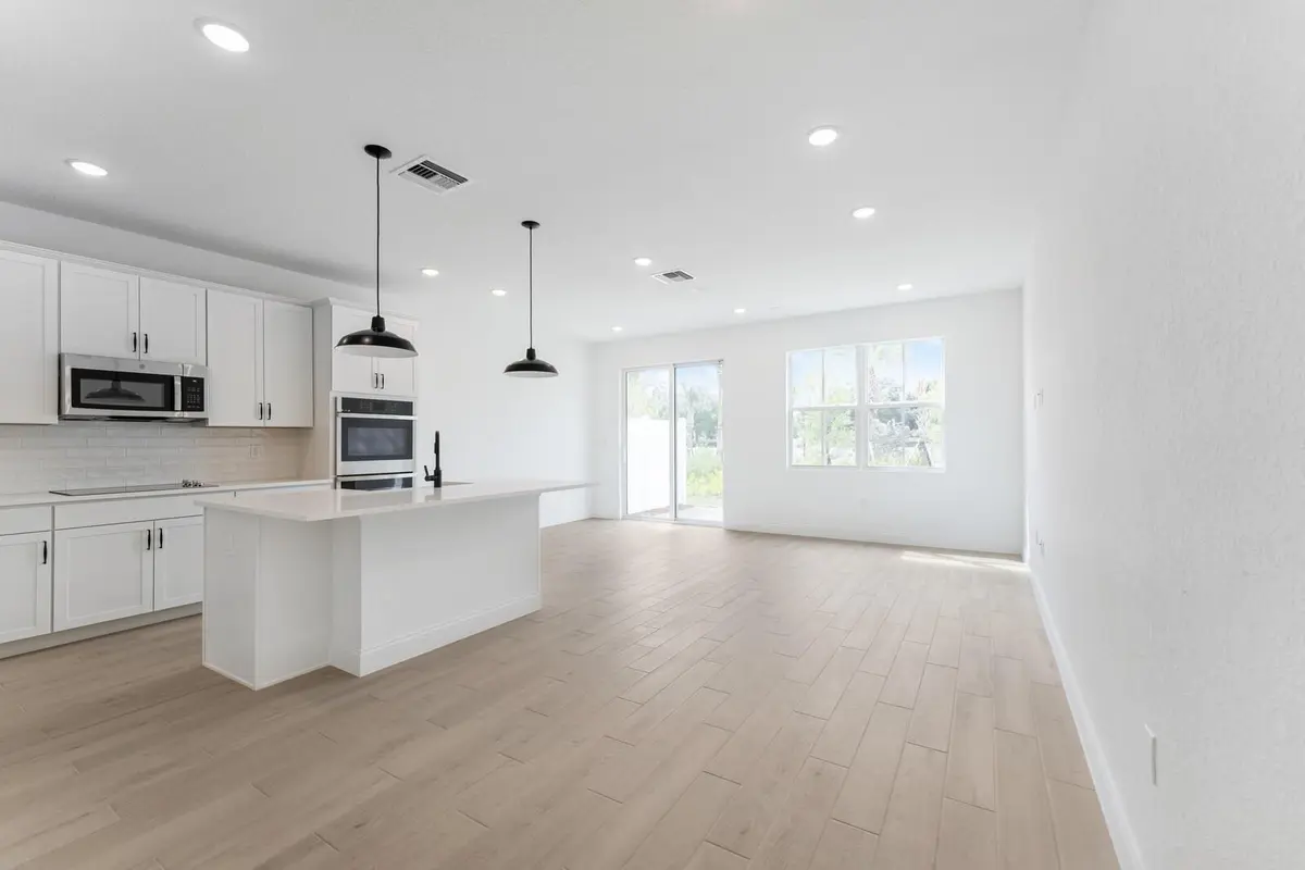 Kitchen, Great Room & Dining Area at 174 SE Birch Terrace 207, Stuart