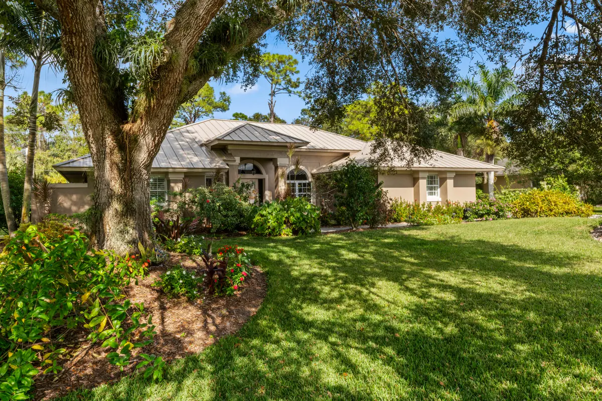 Exterior w/ lush landscaping at 3221 Bent Pine Drive, Fort Pierce