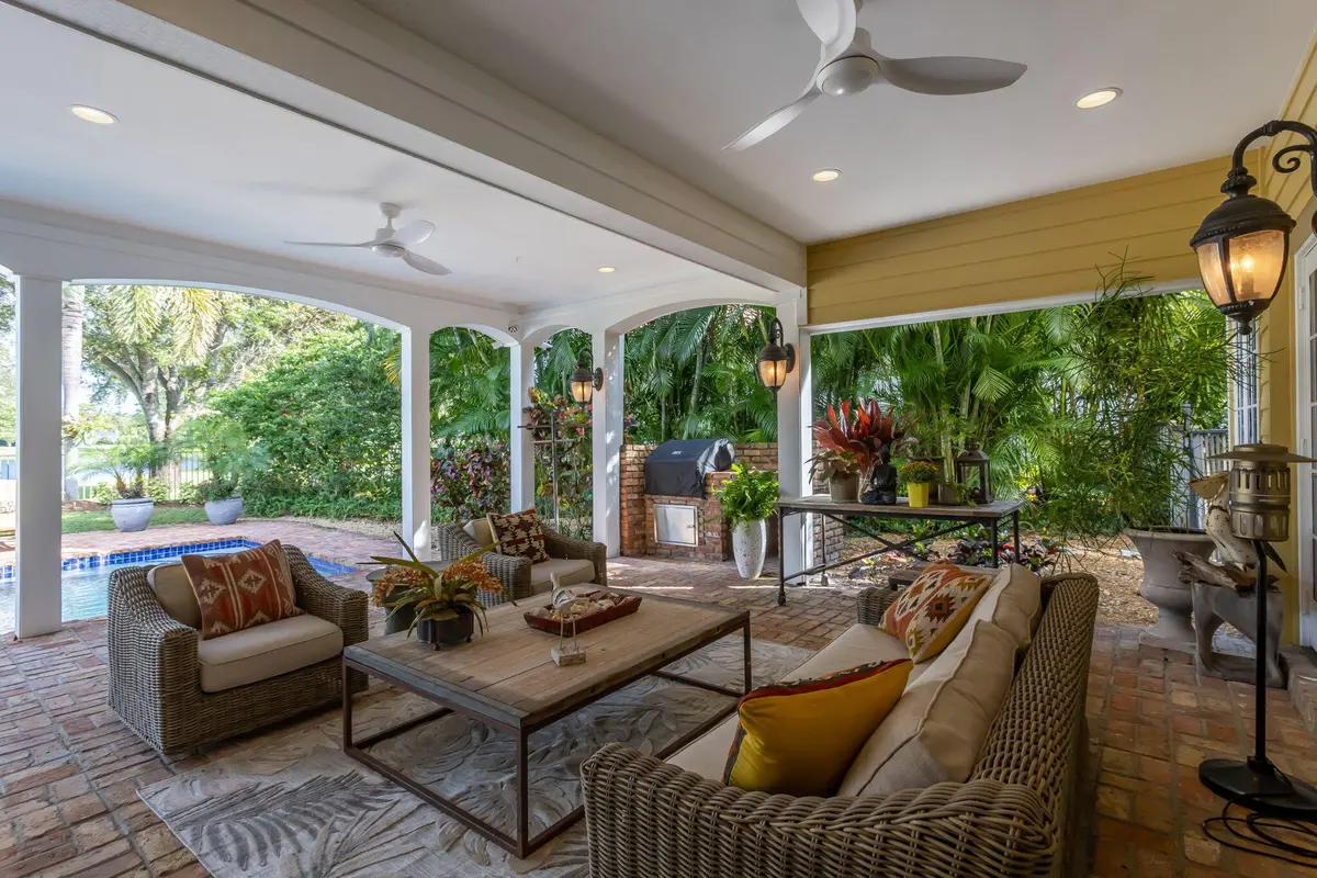 Covered outdoor kitchen and sitting area at 2883 Banyan Boulevard Circle, Boca Raton