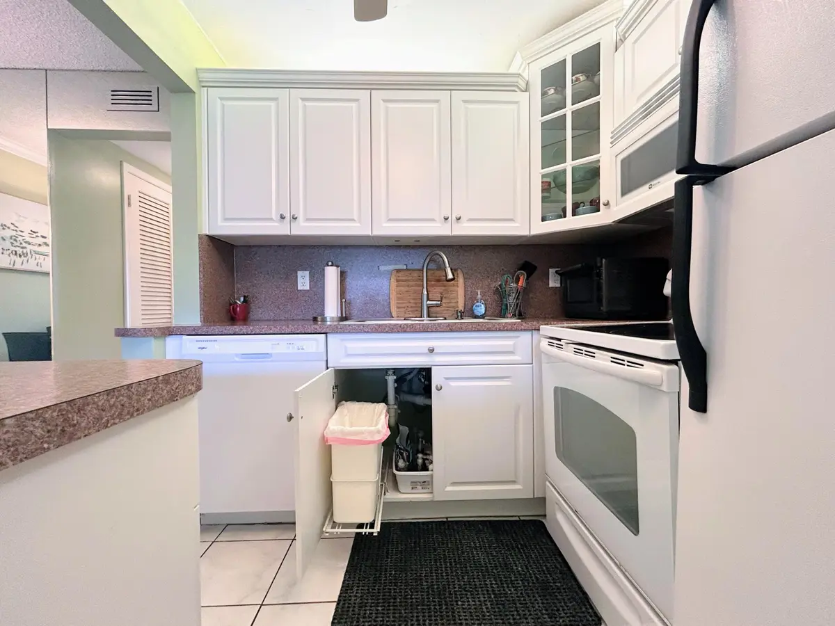 Cabinets w/ pullout trash bin at 450 Horizons E 107, Boynton Beach