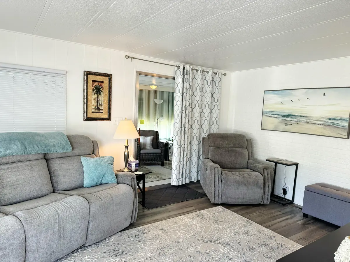 10_Living Room Sofa_Chair_Lanai at 10 SE La Mesa, Port St. Lucie