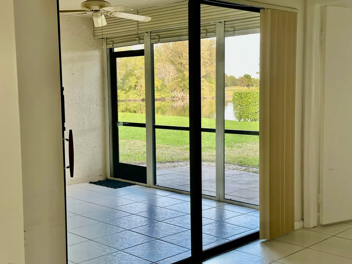 LAKE VIEW FROM LIVING AREA SLIDERS at 5819 Parkwalk Drive, Boynton Beach