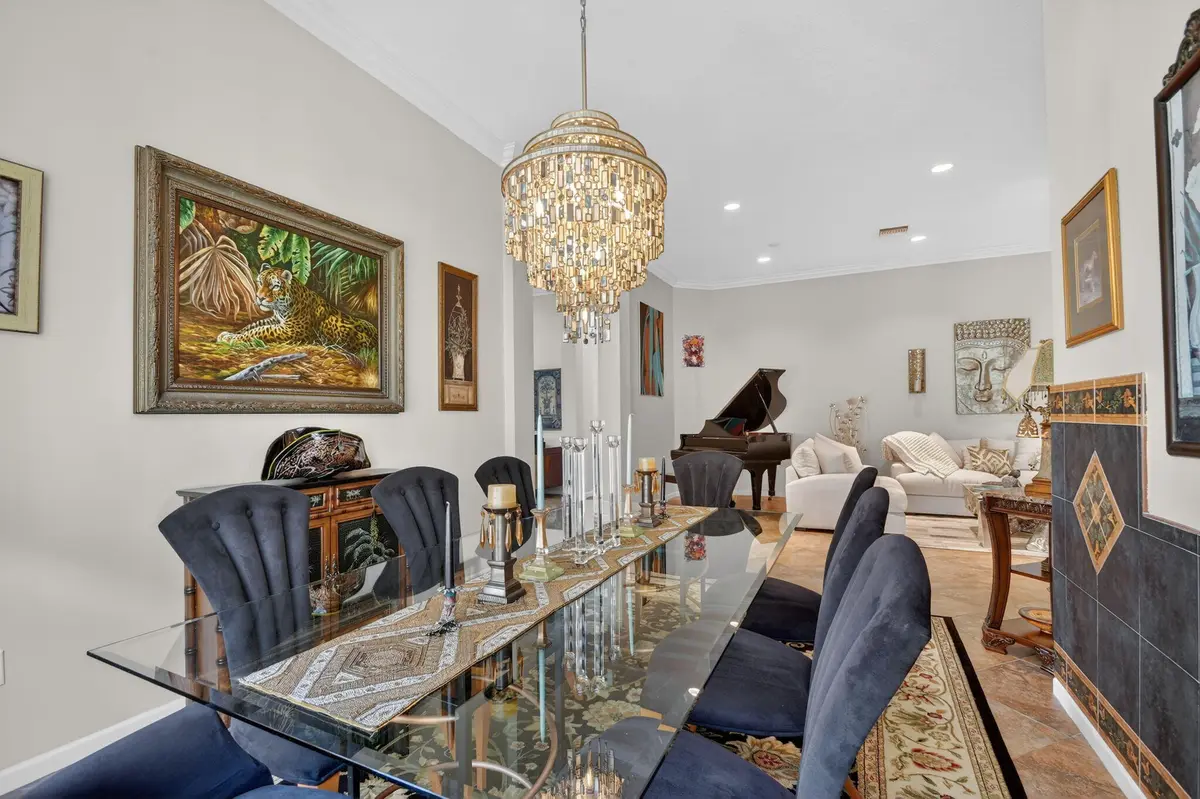 Dining with custom Clive Daniels fixture at 9842 Via Elegante, Wellington