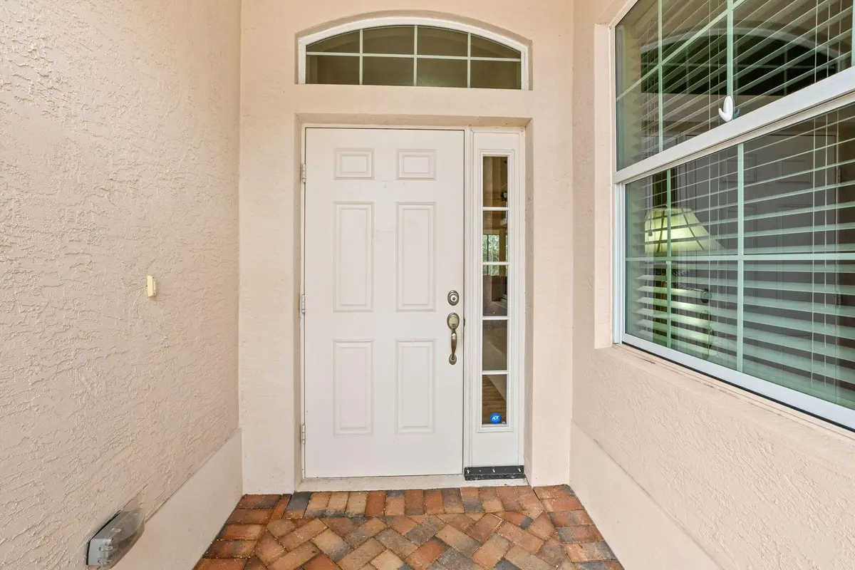 Front door and screened door entrance at 1652 NW Old Oak Terrace, Jensen Beach