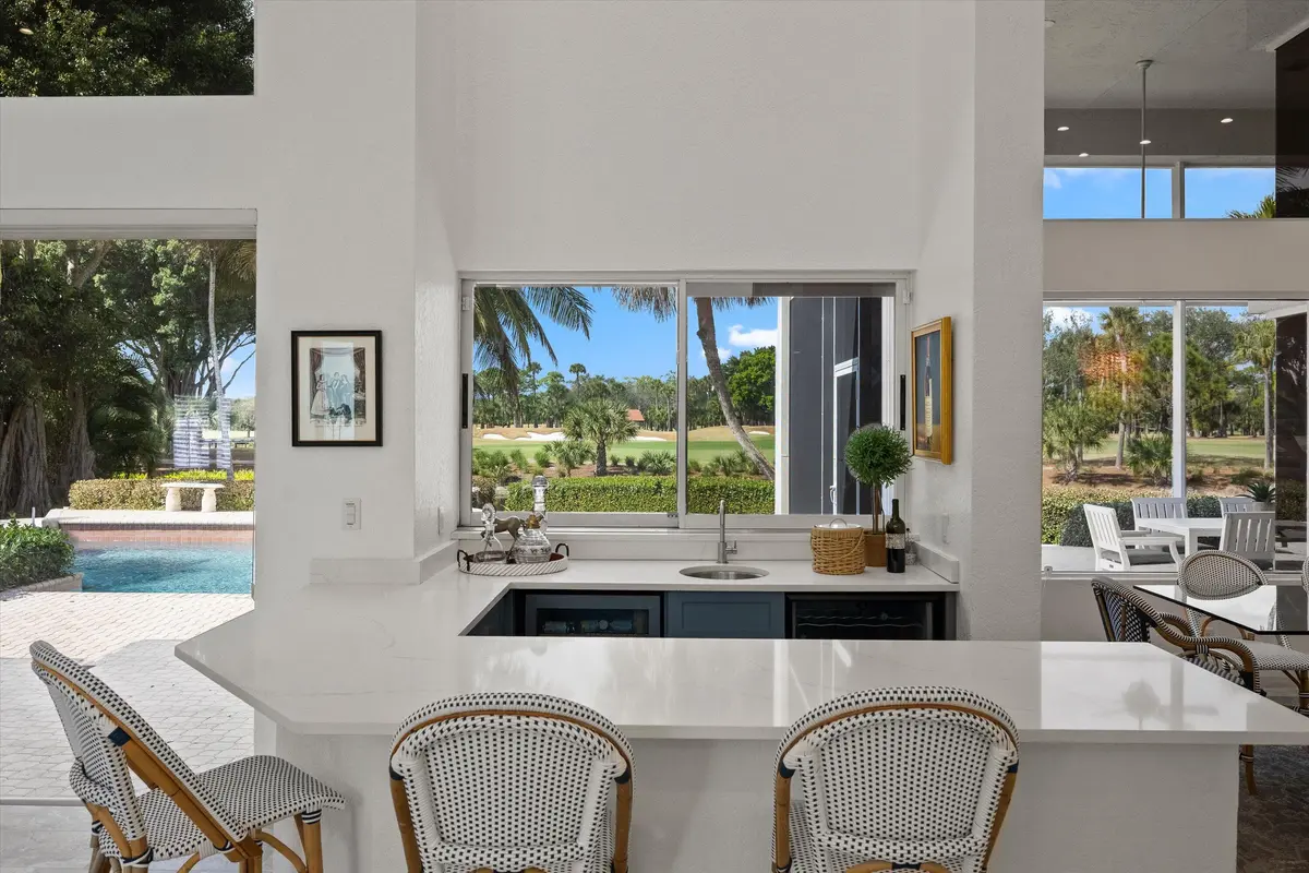 Wet bar with pass thru window at 1362 Breakers West Boulevard, West Palm Beach