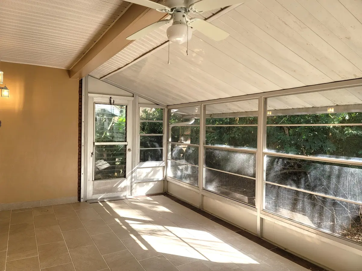FRONT PORCH SCREENED BY TREES AND PLANTS at 4362 W Midway Road, Fort Pierce