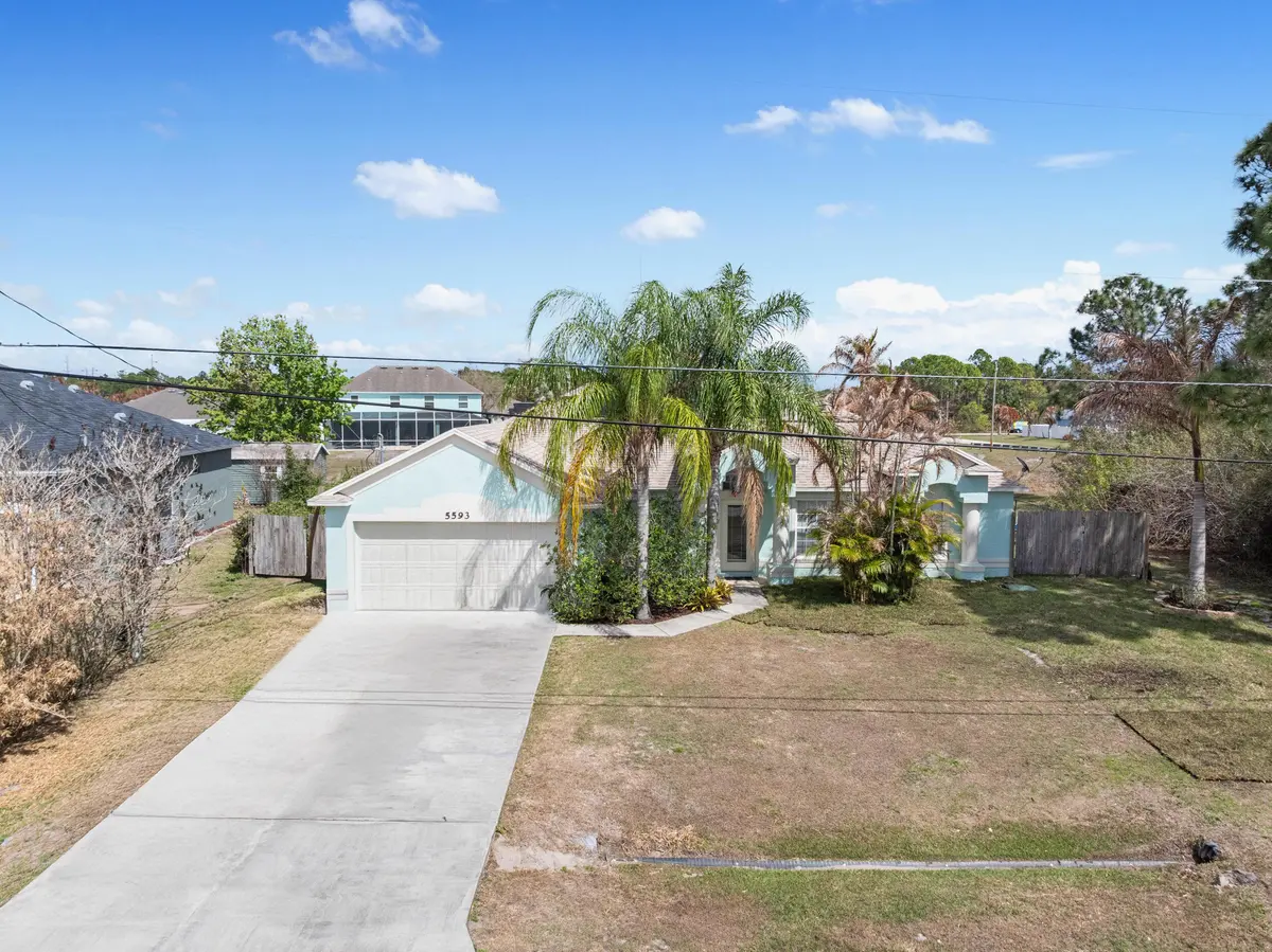 Drone front exterior at 5593 NW Wesley Road, Port St. Lucie