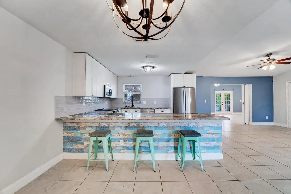 Dining room facing eat in counter at 1918 SE Cheltenham Street, Port St. Lucie