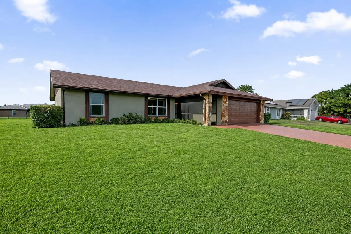 Charming suburban home with green lawn at 140 Miramar Avenue, Royal Palm Beach
