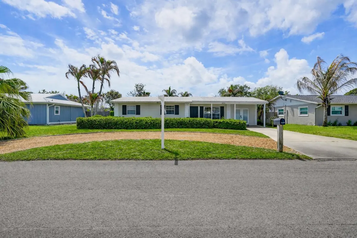 Suburban home with palm trees at 1864 SE Lafayette Street, Stuart