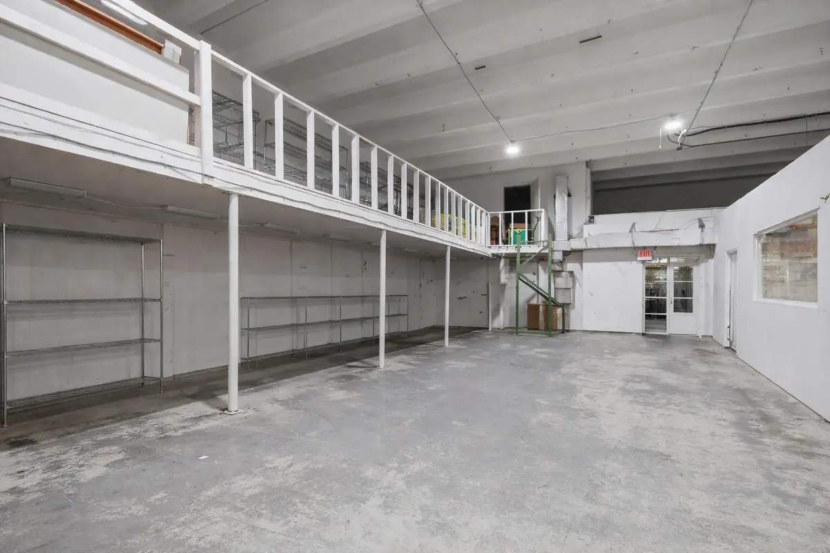Empty warehouse with mezzanine shelving at 1800 N Dixie Highway, Hollywood