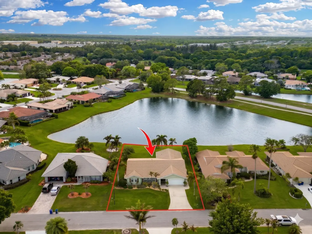 Front high aerial with pond red arrows a at 2306 SW Creekside Drive, Palm City