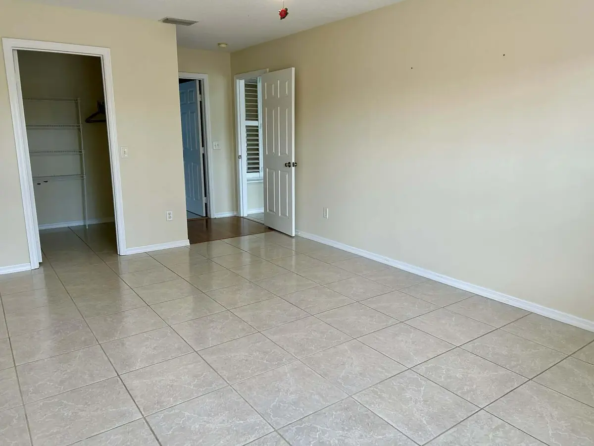 Owner's suite with walk-in closet at 5593 NW Wesley Road, Port St. Lucie