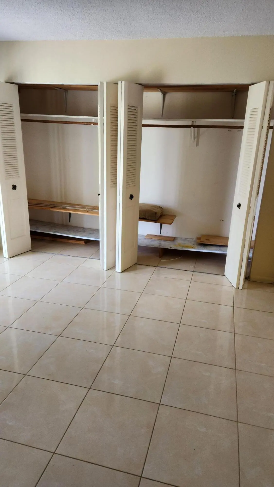 Tiled Bedroom wall of closet space at 102 Andover D, West Palm Beach