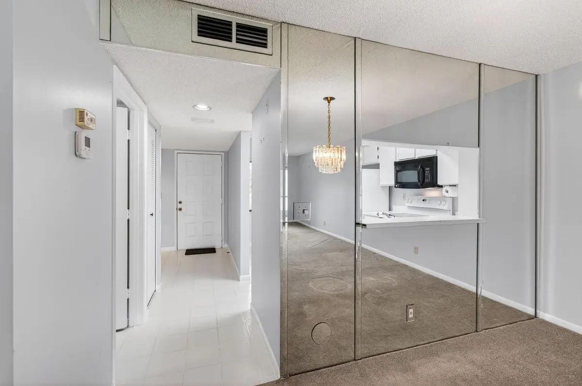 Kitchen behind glass dining area at 6655 Kensington Lane, Delray Beach