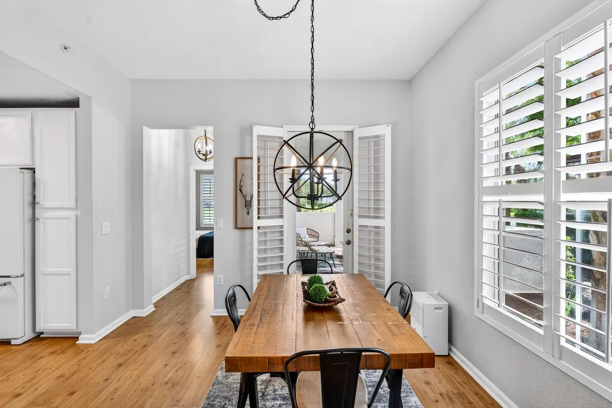 Dining Room with Door to covered Patio at 4680 Mimosa Place 805, Coconut Creek