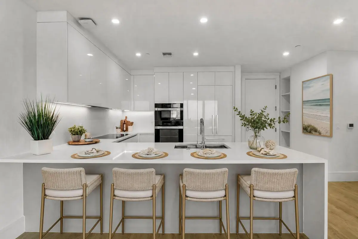Kitchen bar with stools - Staged at 220 Lake Shore Drive 815, Lake Park
