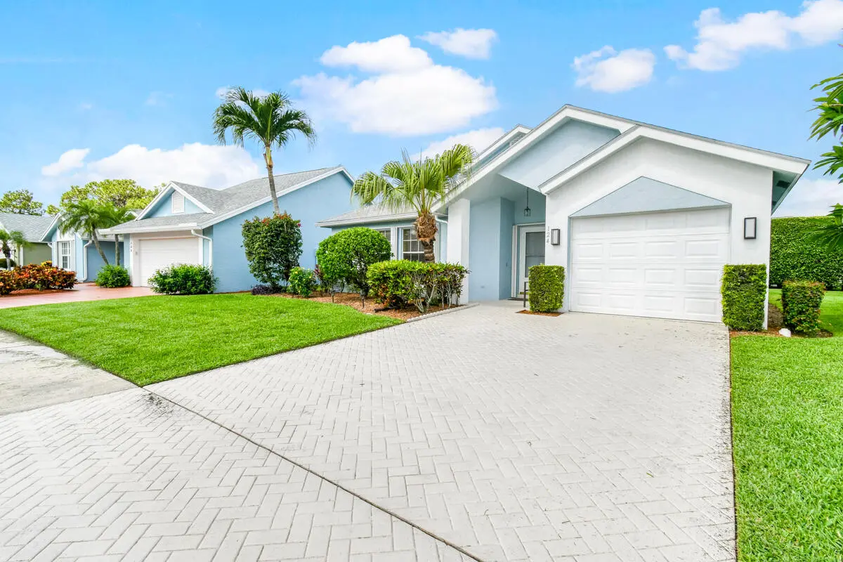 front of home at 124 Adobe Circle, Jupiter