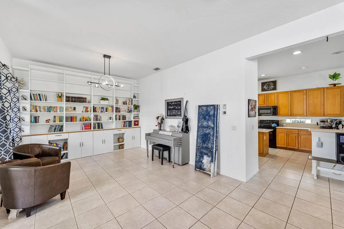 Bookshelf/lead into kitchen at 140 Bellezza Terrace, Royal Palm Beach