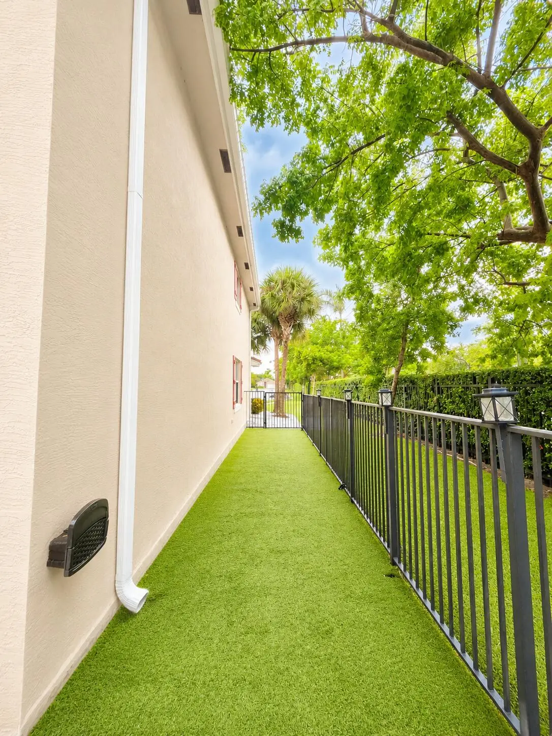 Side of house/ turf at 4773 Foxtail Palm Court, Greenacres