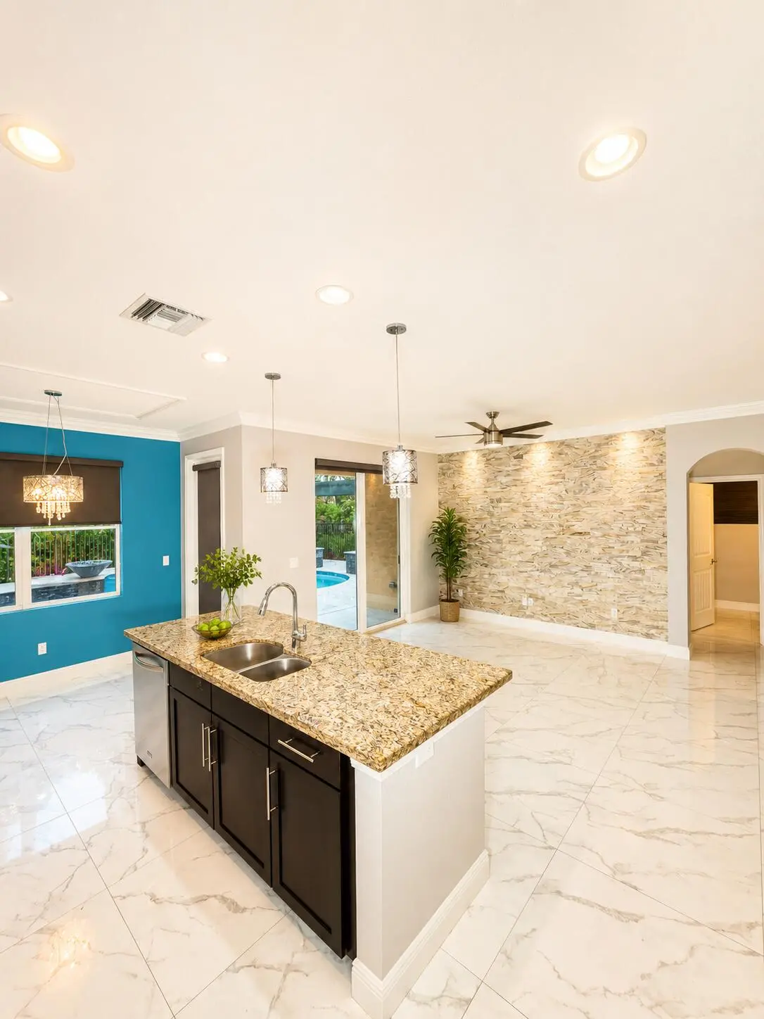 Kitchen Island and great room at 4773 Foxtail Palm Court, Greenacres