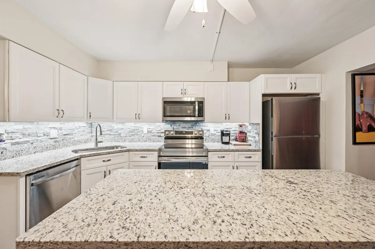 Modern kitchen with stainless appliances at 11000 S Ocean Drive 2-6, Jensen Beach
