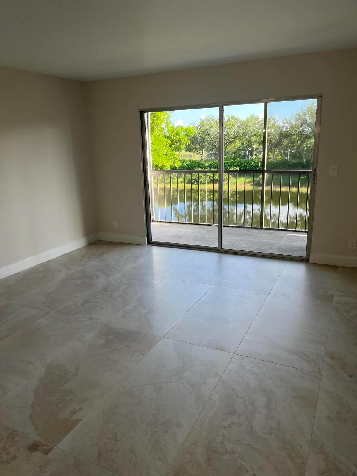 Living room w lake view at 7321 Amberly Lane 302, Delray Beach