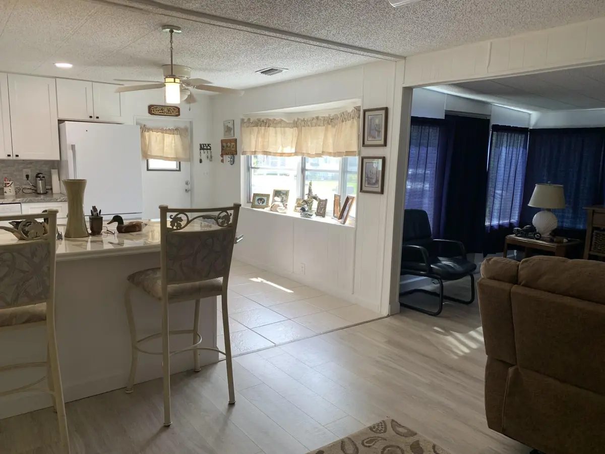 Dining to Kitchen and Den at 8 Brisa Lane, Port St. Lucie