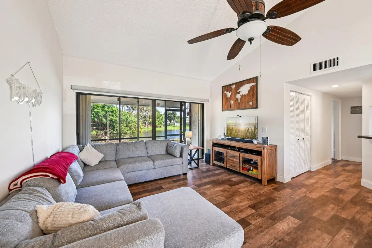 Living Room and Patio Access at 22 VIA DE CASAS SUR 103, Boynton Beach