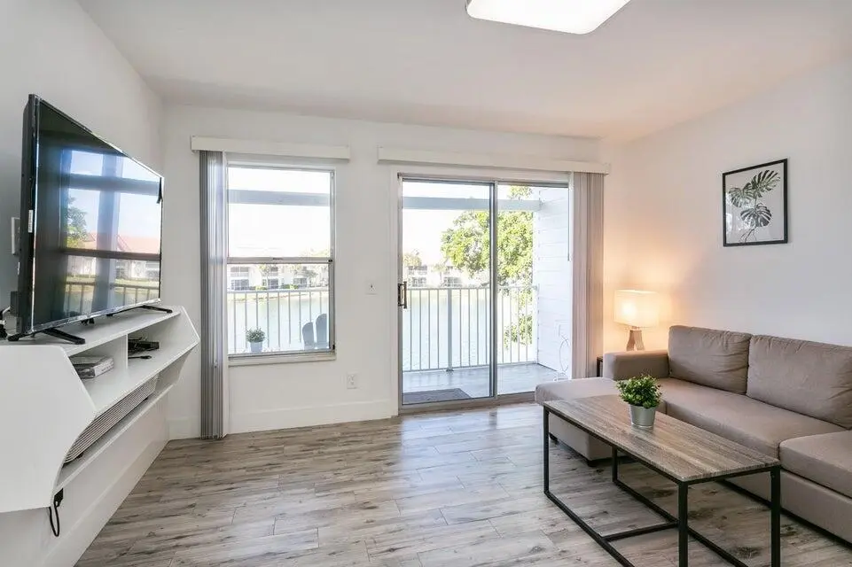 Living Area, Balcony & Lake at 275 Cypress Point Drive, Palm Beach Gardens