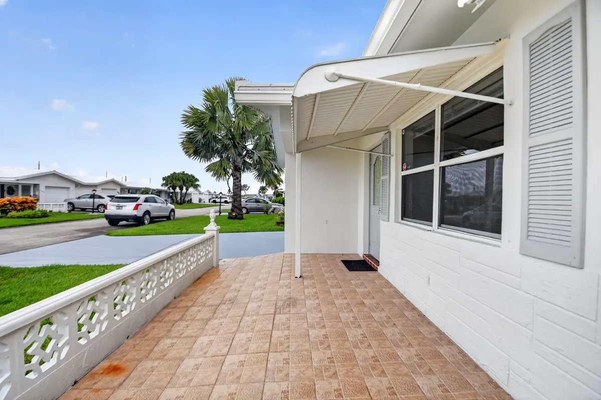 Tiled front porch/ New glass/Shutters at 2091 SW 13th Terrace, Boynton Beach