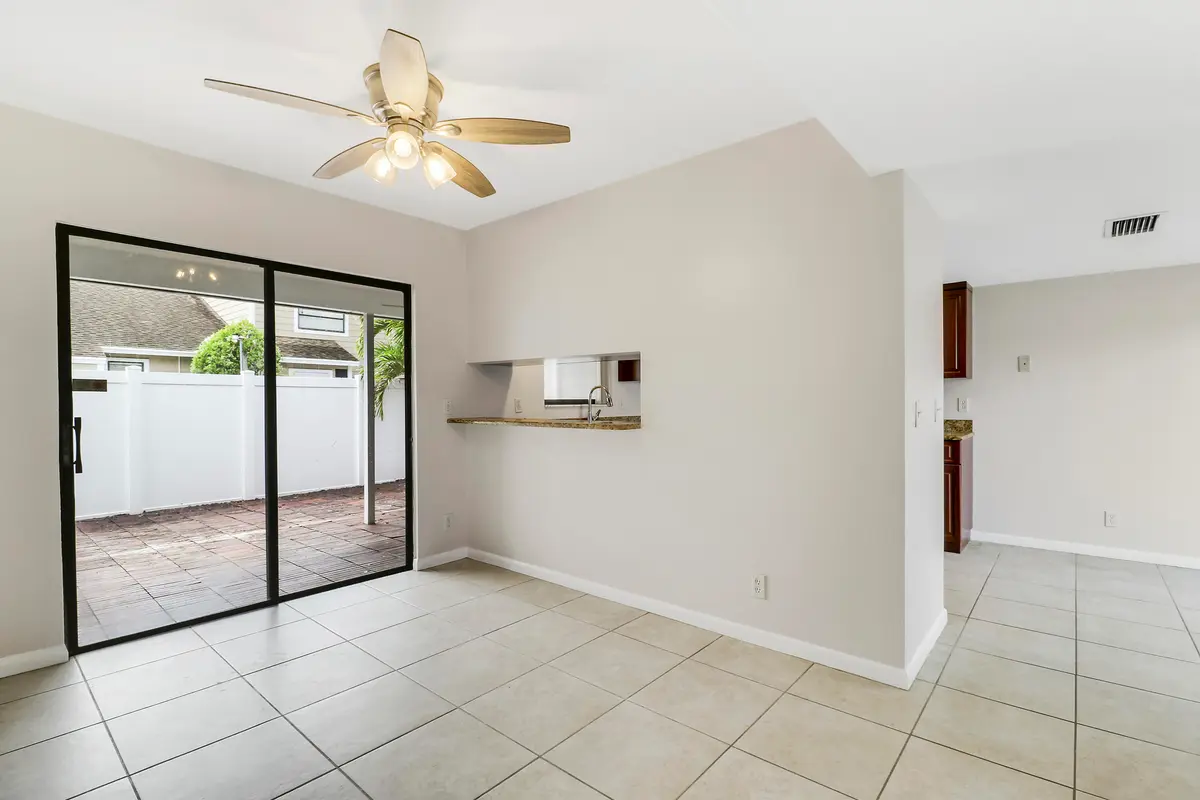 Living area facing kitchen at 202 LAKEWOOD Drive 11B, Jupiter