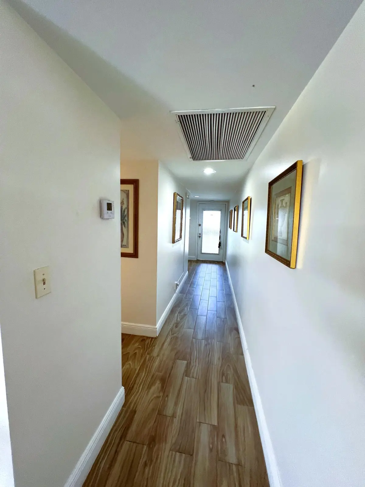 Hallway to Half Bath and Bedroom at 3402 Bimini Lane G4, Coconut Creek