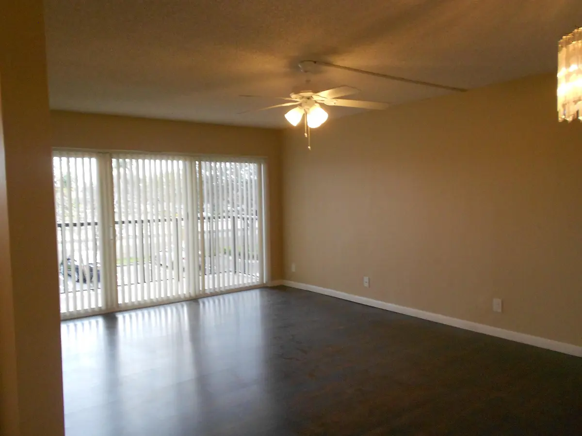 Living Area with large balcony at 8977 Wiles Road 203, Coral Springs