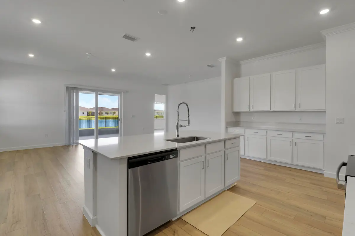 Kitchen angle with Great room background at 1113 SE CROSSWOOD Way, Port St. Lucie