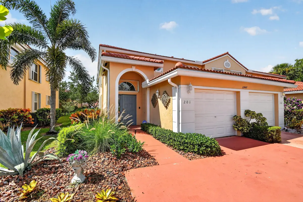 Entrance with one car garage at 12447 Crystal Pointe Drive 201, Boynton Beach