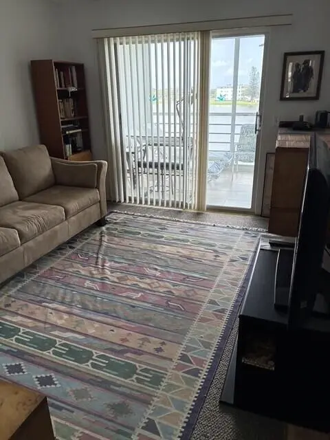 Living Room and Patio with Lake View at 3025 Ainslie B Drive, Boca Raton