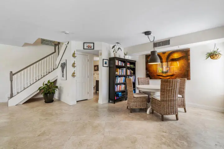 123 102 dining table and bookcase at 123 Yacht Club Way 102, Hypoluxo