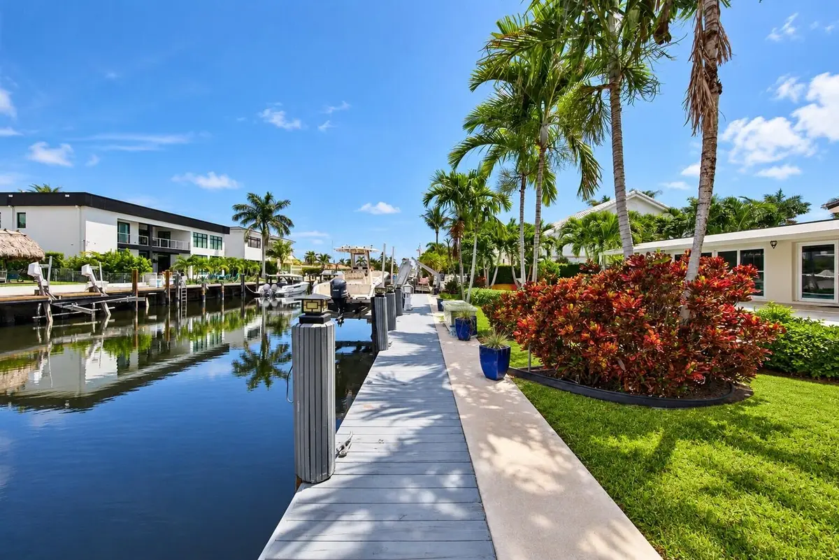 Clean canal and remove teal chairs at 2401 NE 47TH Street, Lighthouse Point