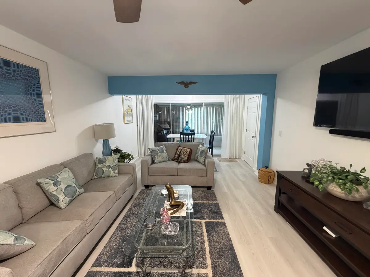 Living room to patio at 1111 Lemon Tree Terrace 104, Delray Beach