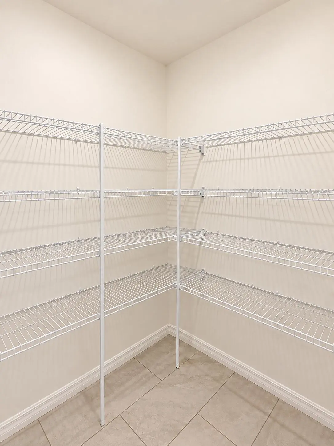 Bright Empty L-Shaped Pantry Shelving at 1025 SW SARTO Lane, Port St. Lucie