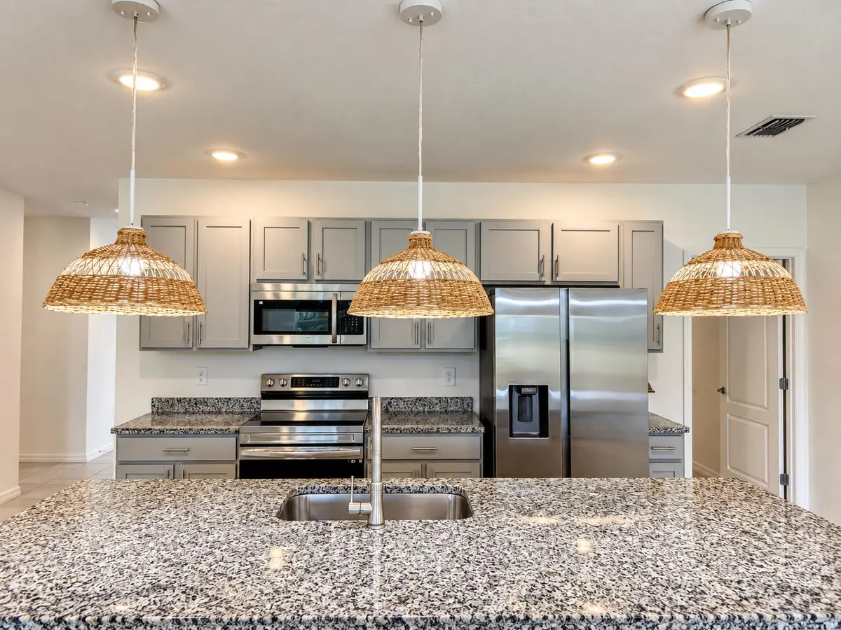 Warm Modern Wicker-Lit Kitchen at 1025 SW SARTO Lane, Port St. Lucie