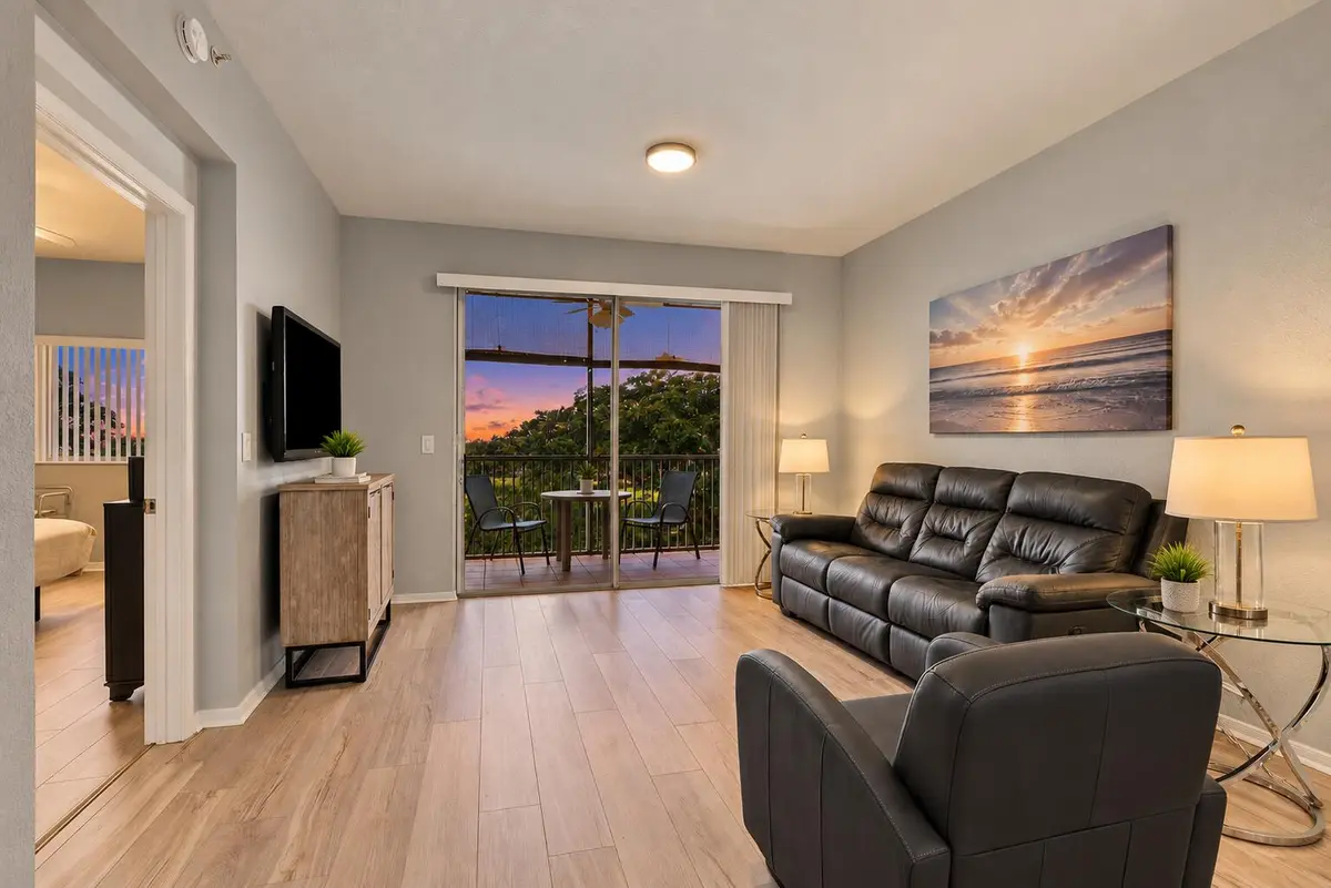 Modern Living Room with Balcony Twilight at 7755 Yardley Drive 410, Tamarac