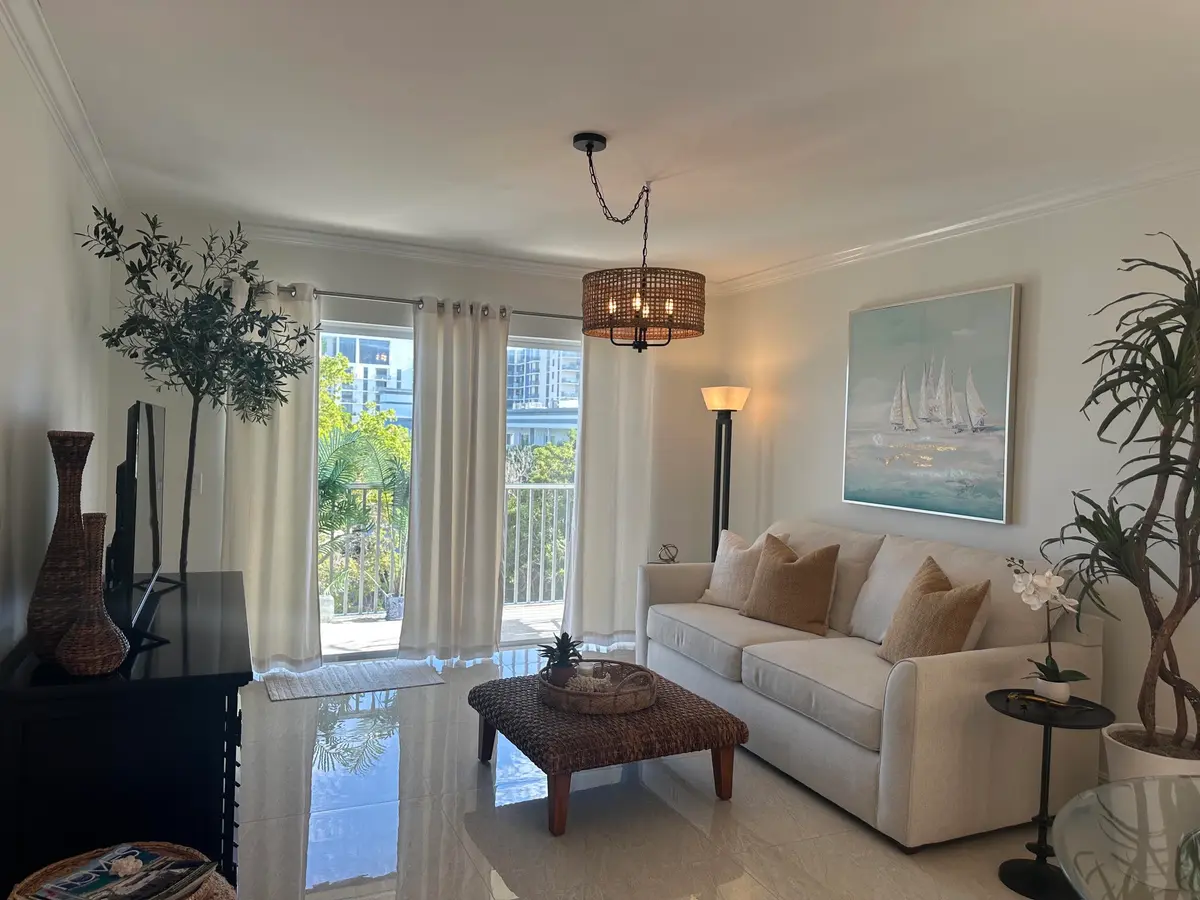 Living room with slider to lanai at 646 Snug Harbor Drive H407, Boynton Beach